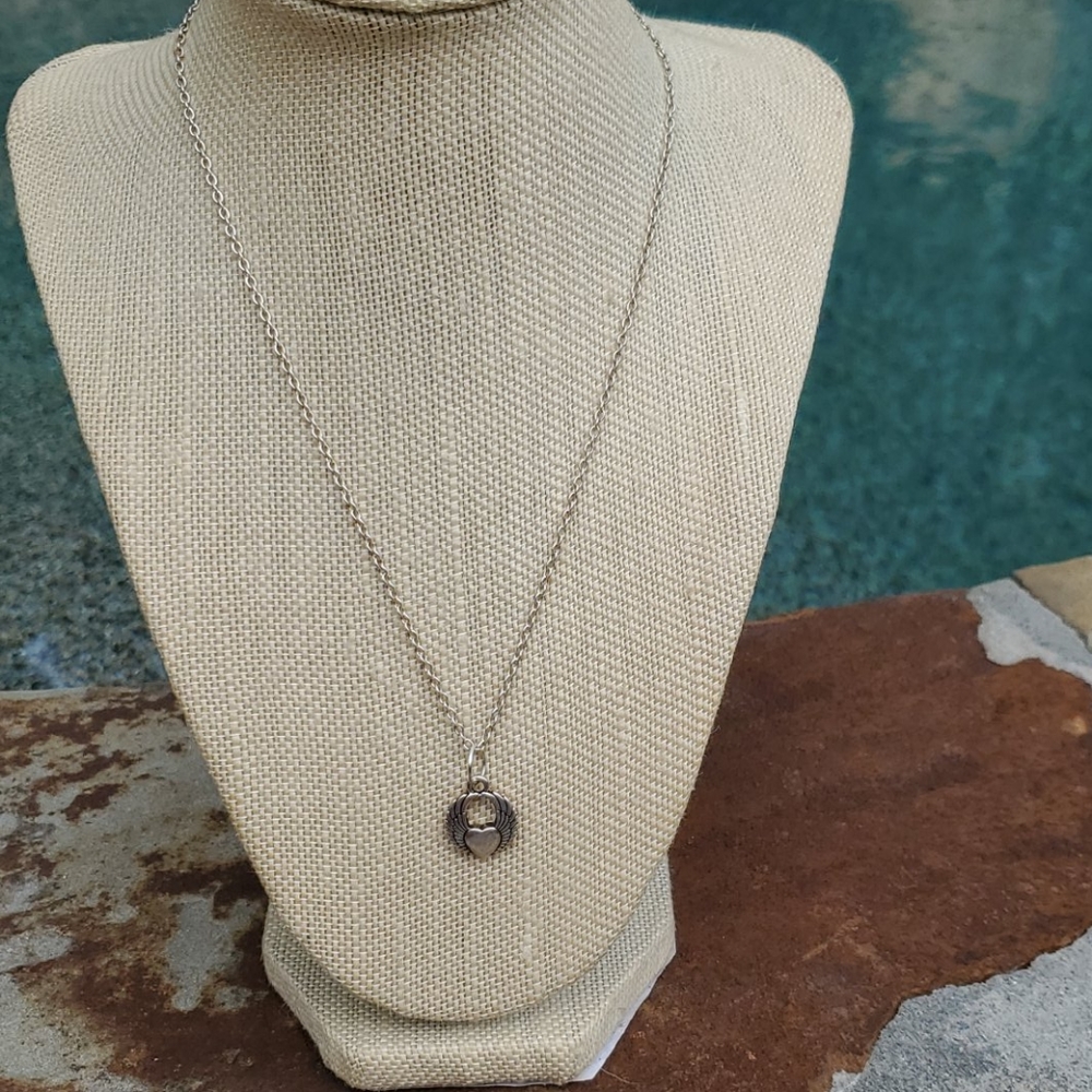Silver plated necklace with heart charm.